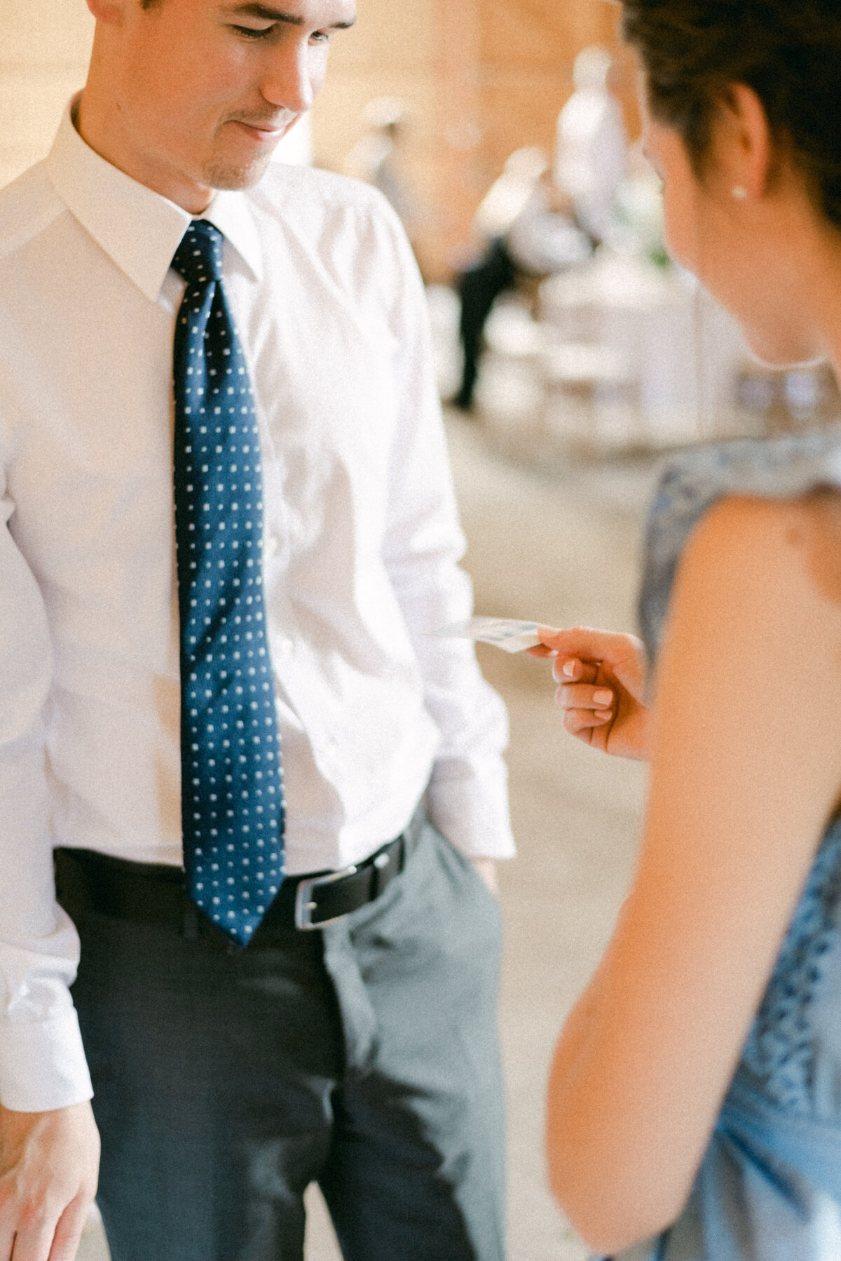 Guests looking at a polaroid in an image captured by wedding photographer Hannika Gabrielsson.