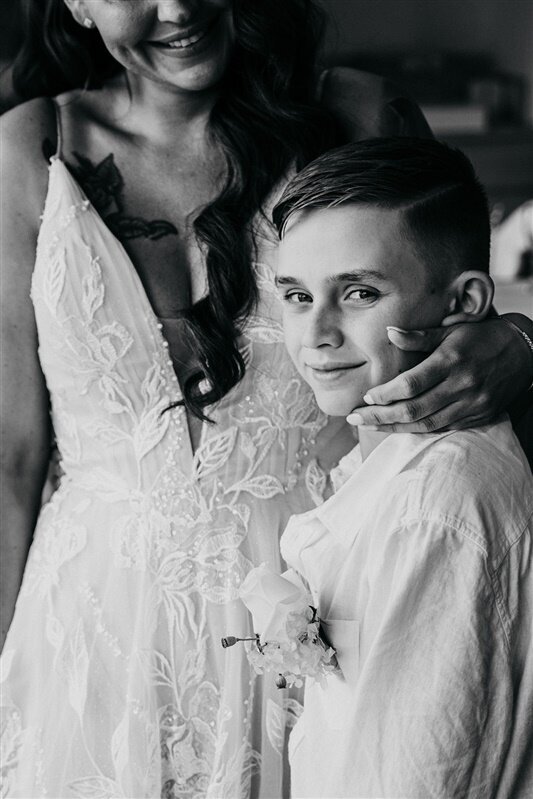 Experience the tender moment when Tamara shares a heartfelt embrace with a special young man just before her wedding ceremony.