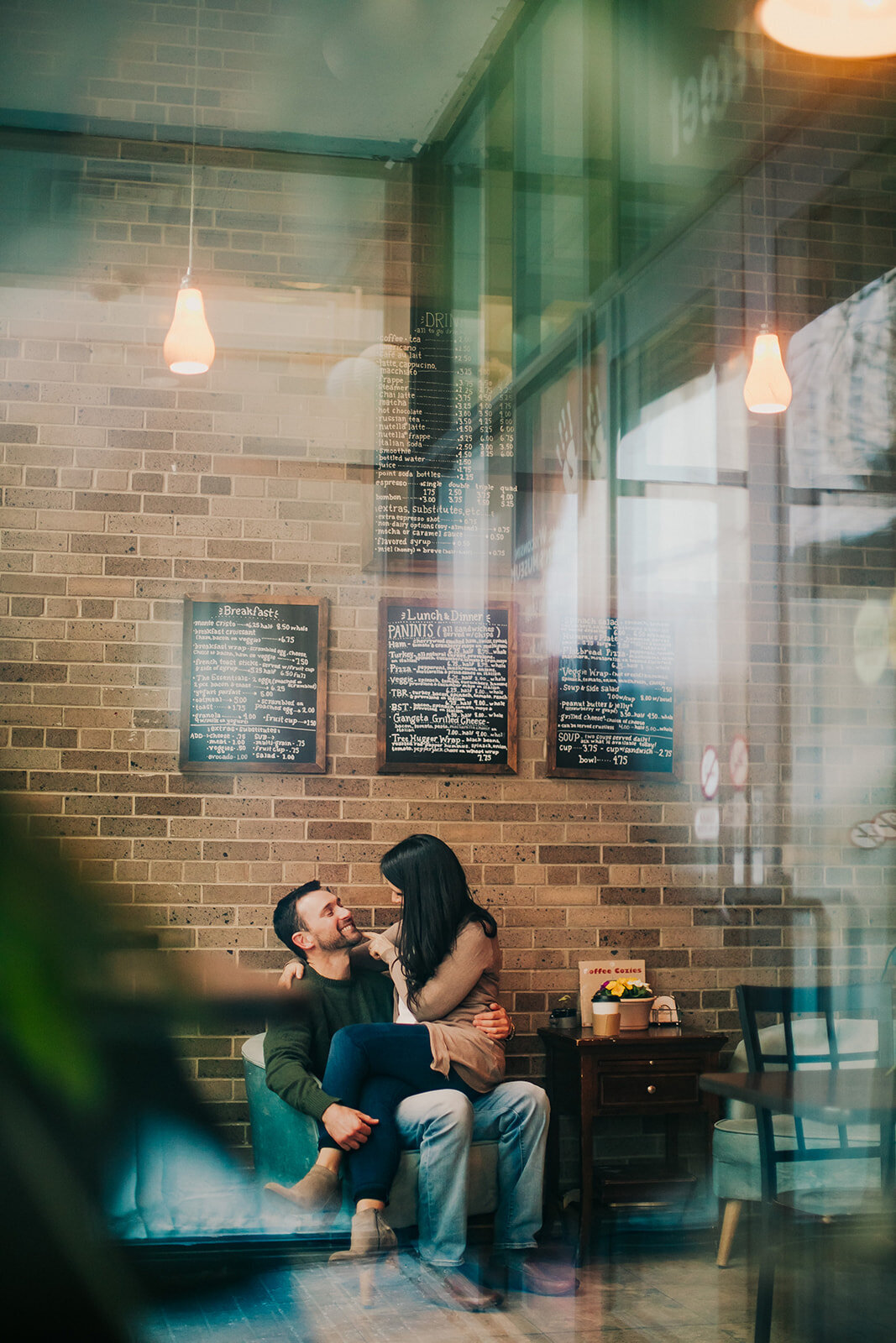 A woman sits on a man's lap at the Coffee Studio