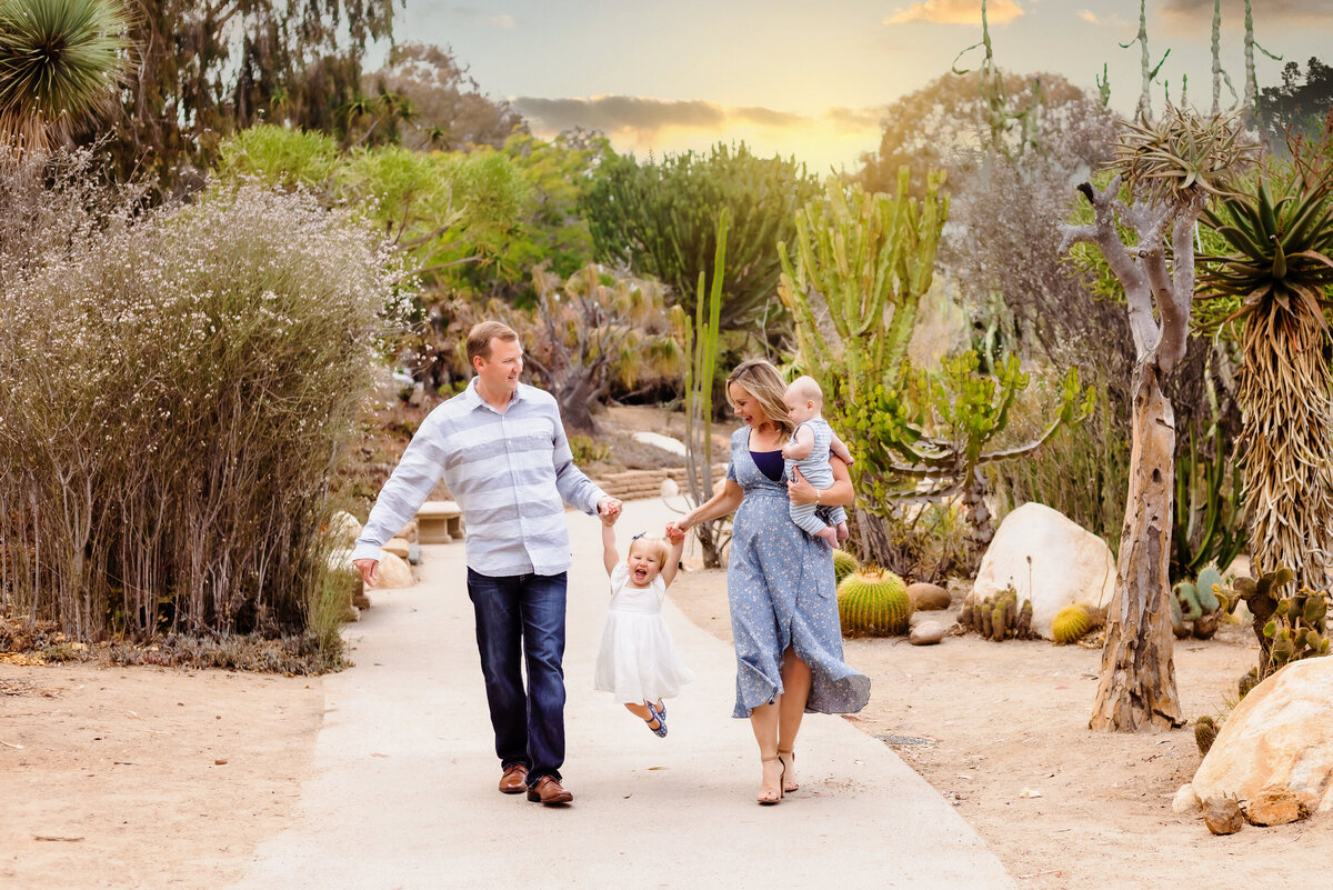 Family Photographer, a family of four walk together on a path outside