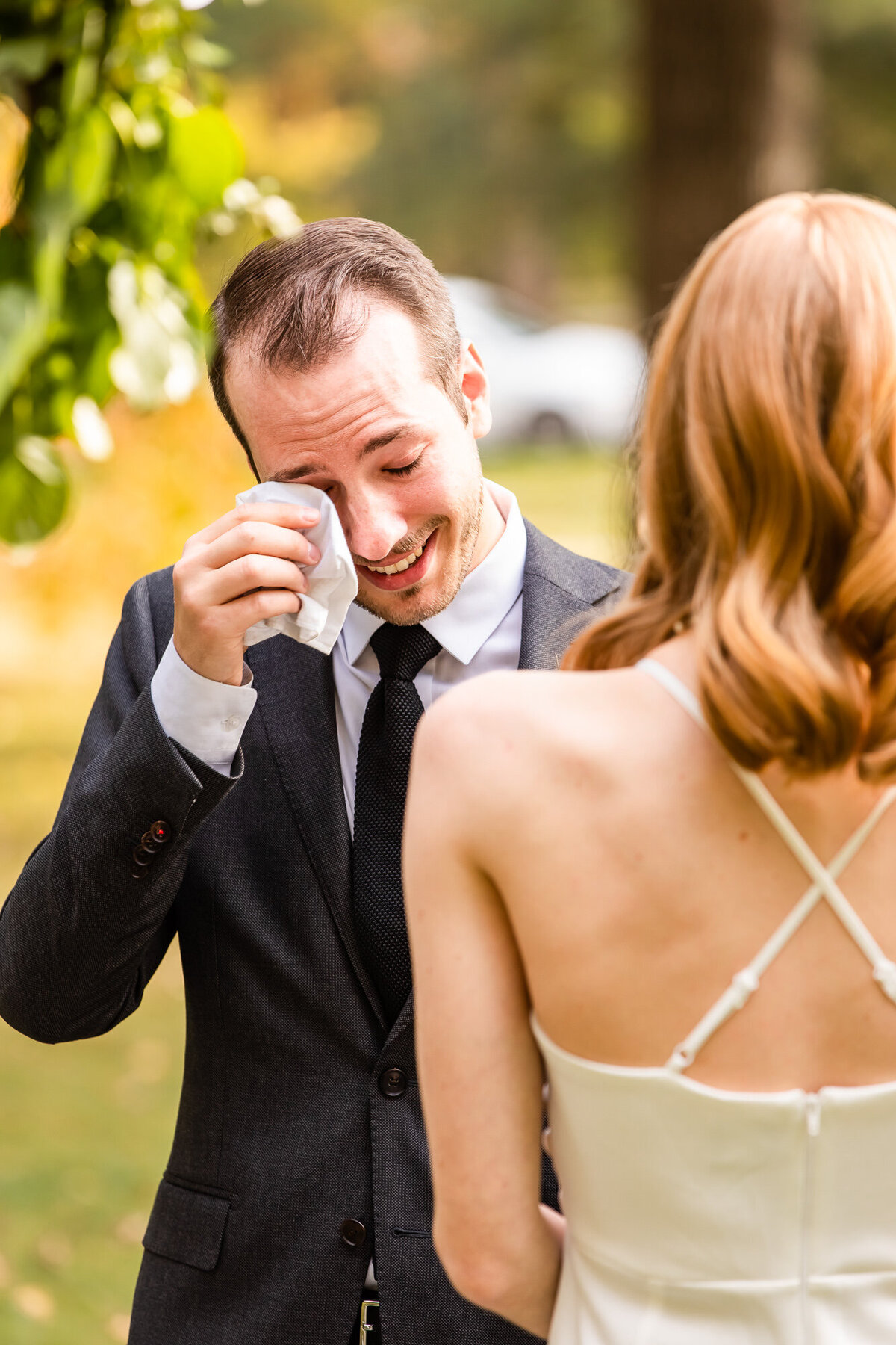 Groom crying during wedding vows at his outdoor intimate wedding ceremony