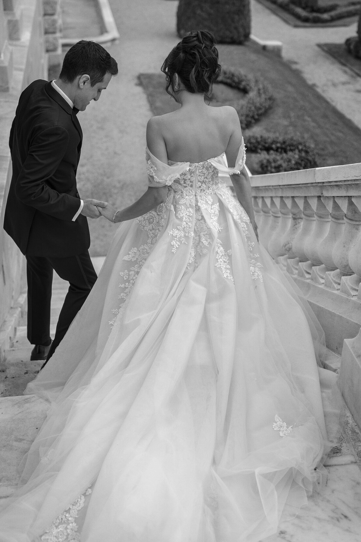 Bride and Groom walk down the steps into the sunken garden at The Elms Mansion.