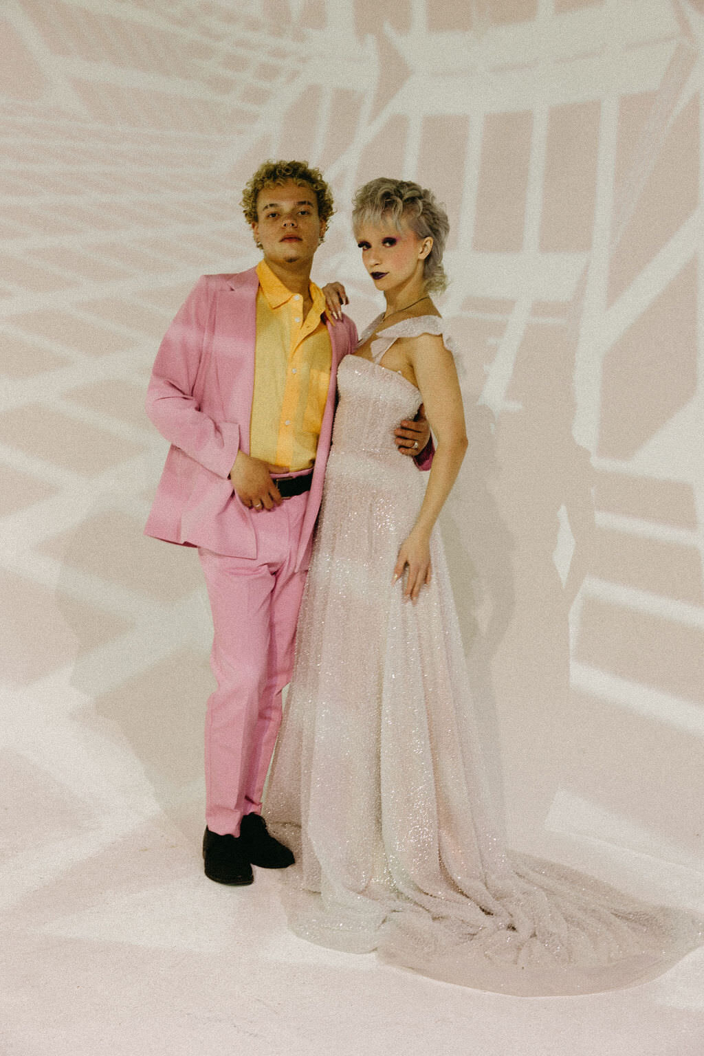 A wedding couple standing together with light lines projected on them.