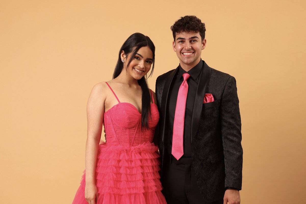 A couple wearing a dress and men’s formal wear for prom