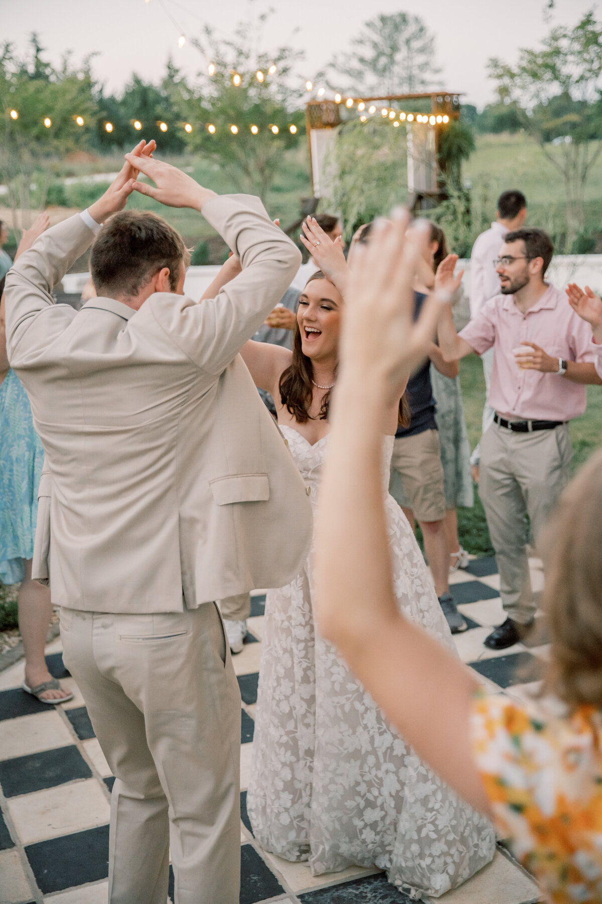 Bride and groom dance with their friends at Three Oaks Manor
