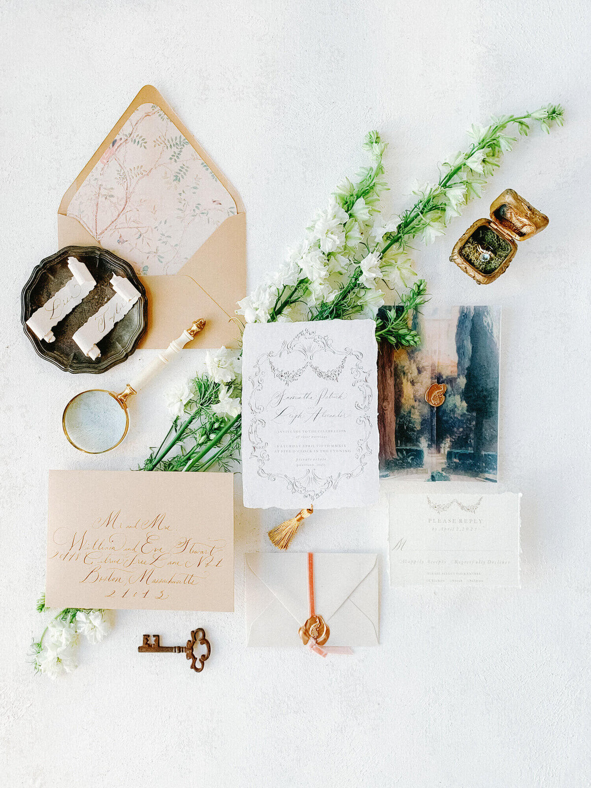 flat lay image of watercolor wedding invitation suite