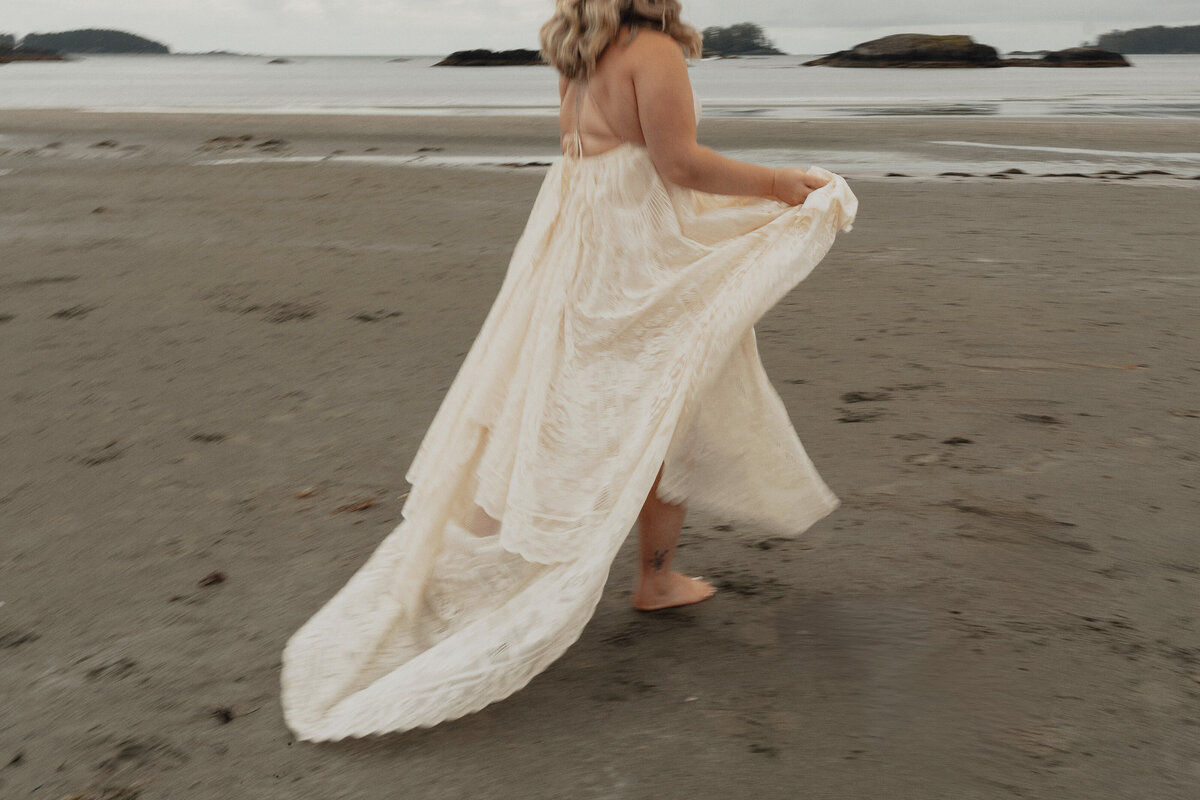 bride during her elopement photos on Mackenzie beach in tofino by latitude 49 photography
