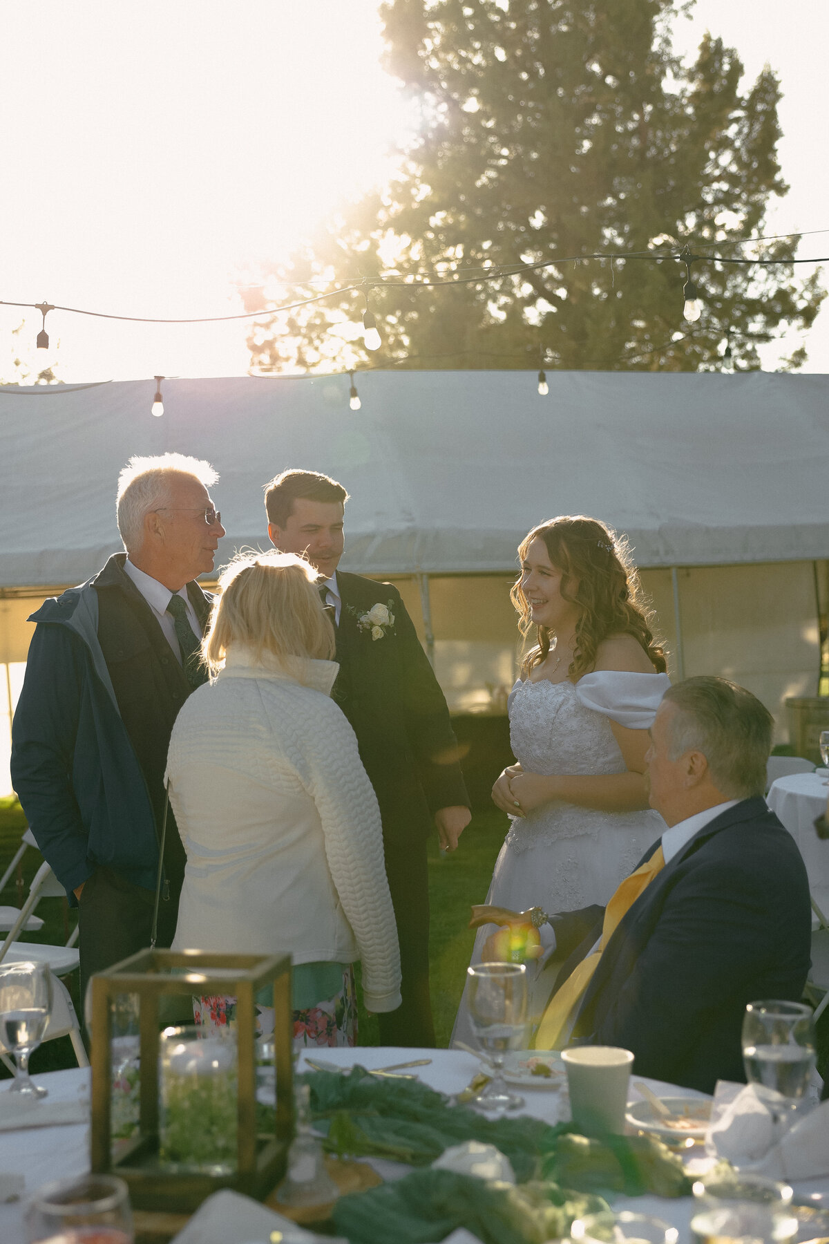 Golden-Hour Conversation Between Bride and Guests | Oregon Wedding Reception Photography