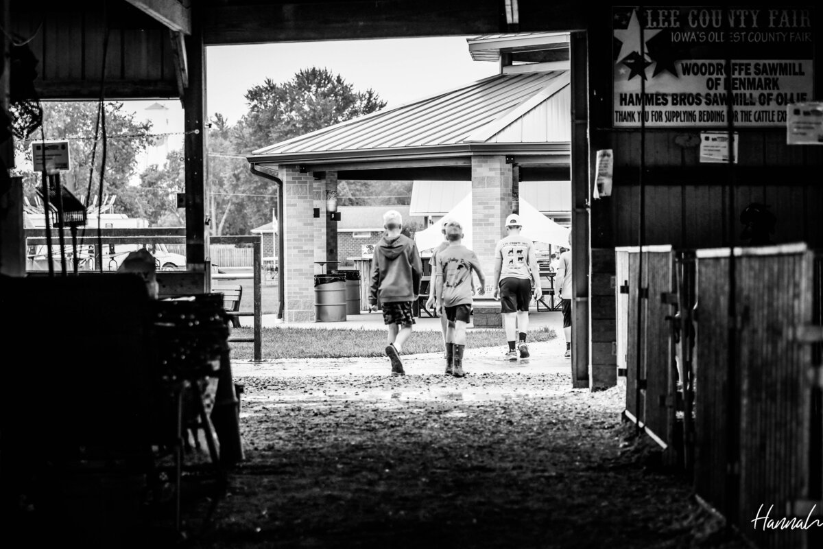 young kids walking the barns at fair