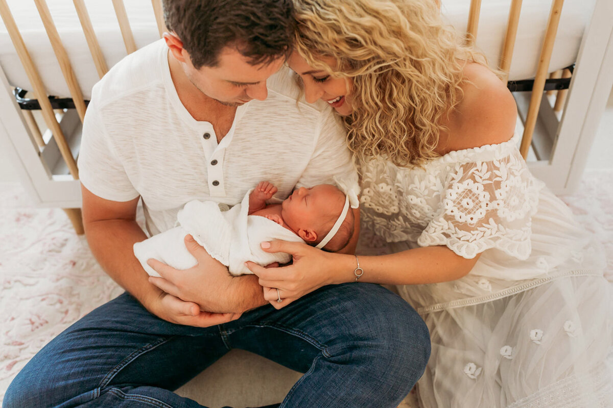 parents crib holding baby