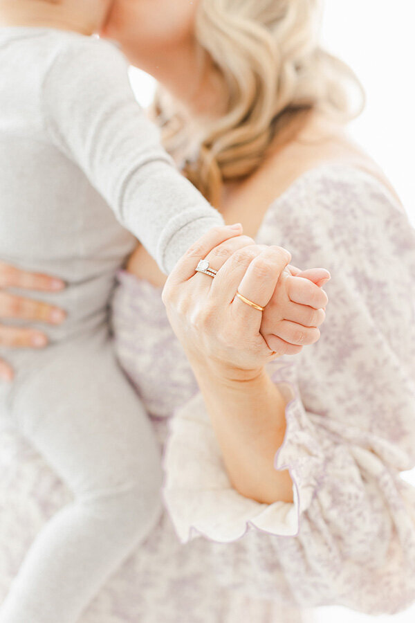 A Northern Virginia Newborn Photographer photo of a mother holding her baby's hands