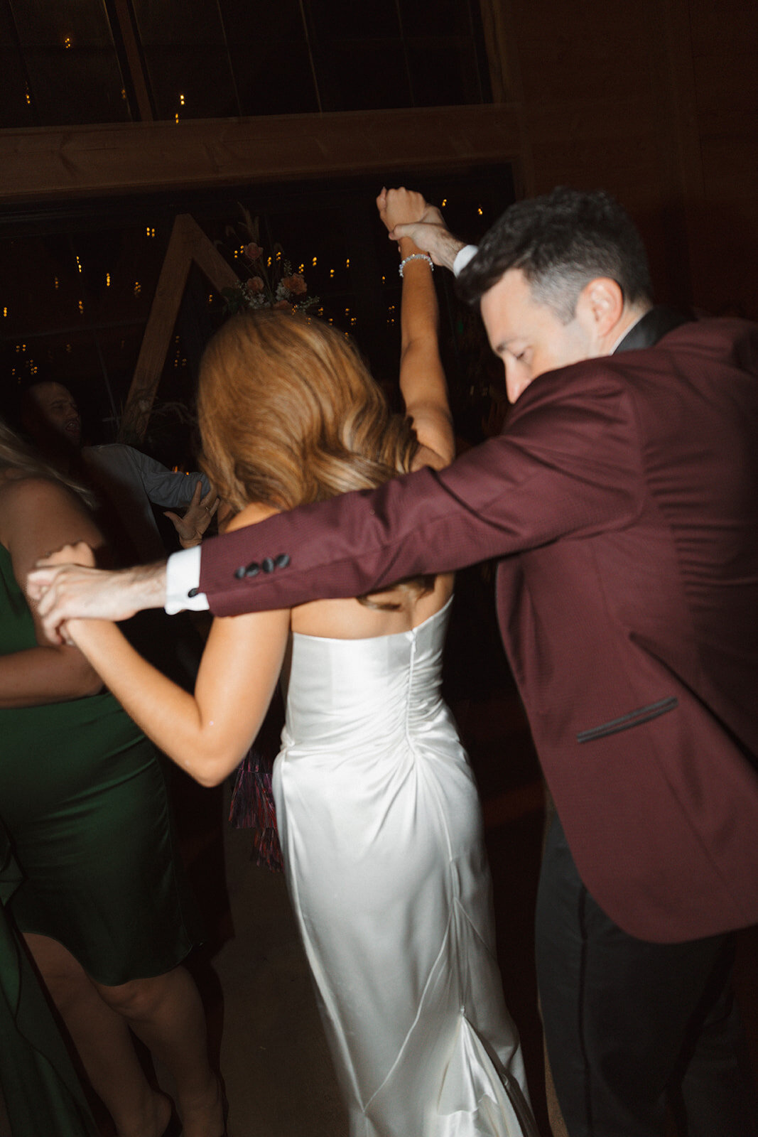 Bride and groom head towards the dance floor at their wedding at The Lake House on Canandaigua