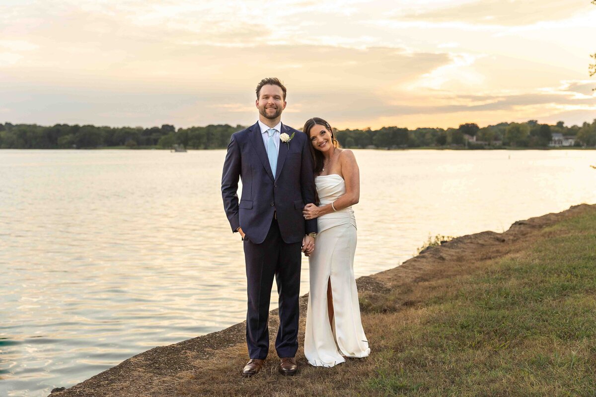 Bride and groom holding each other smiling