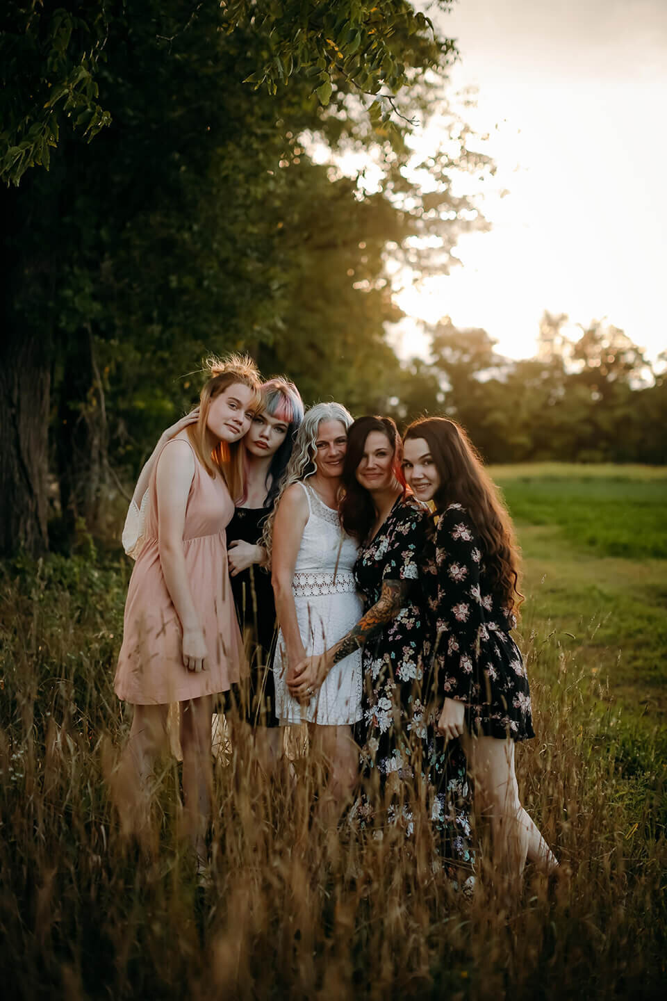 mother and four daughters standing in a field