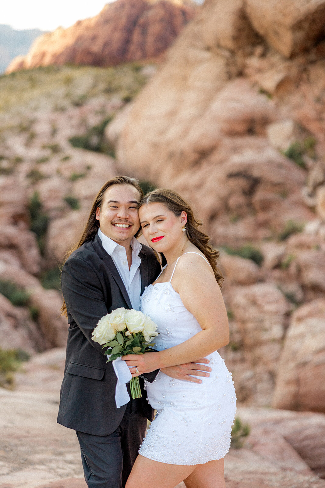 Engaged couples holding each other smiling at the Red Rock Canyon