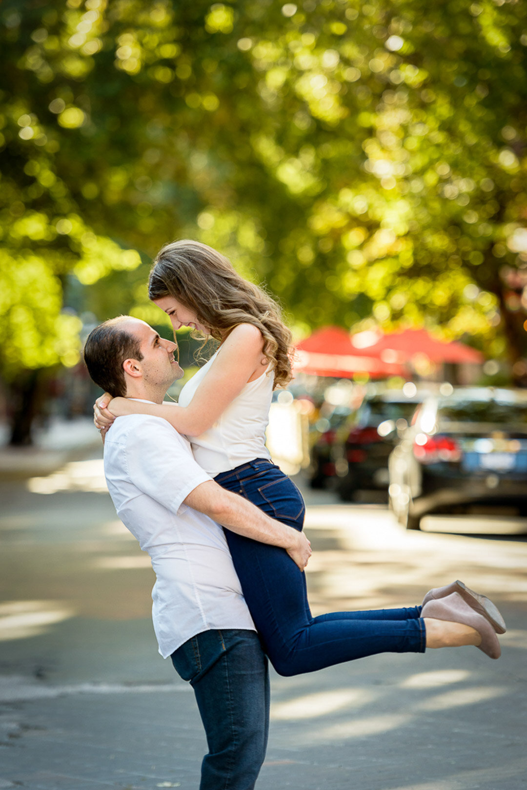 Lifting fiancee on cobblestone road in Gastown 2