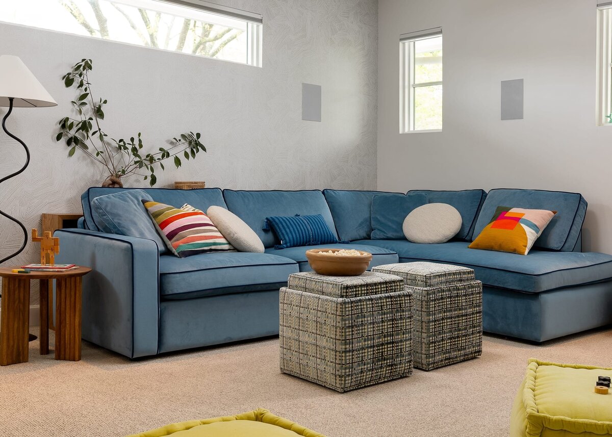 rebekah nicole interiors arbor playroom blue sofa and colorful pillows