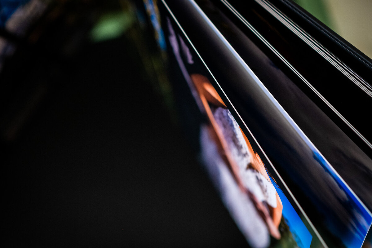 A top-down view of fanning through several wedding album pages