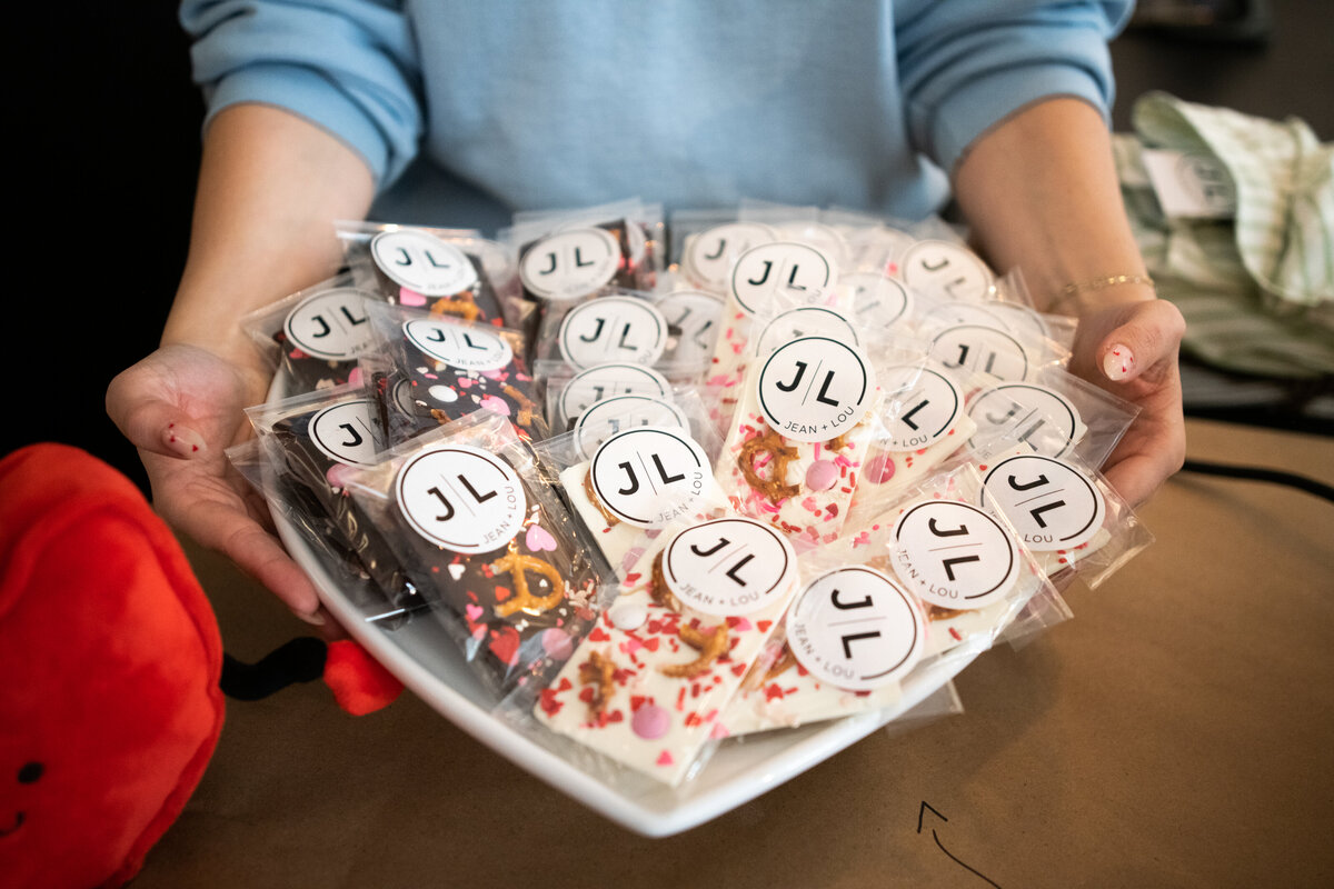 womans hands holding plate of sweets at Jean and Lou