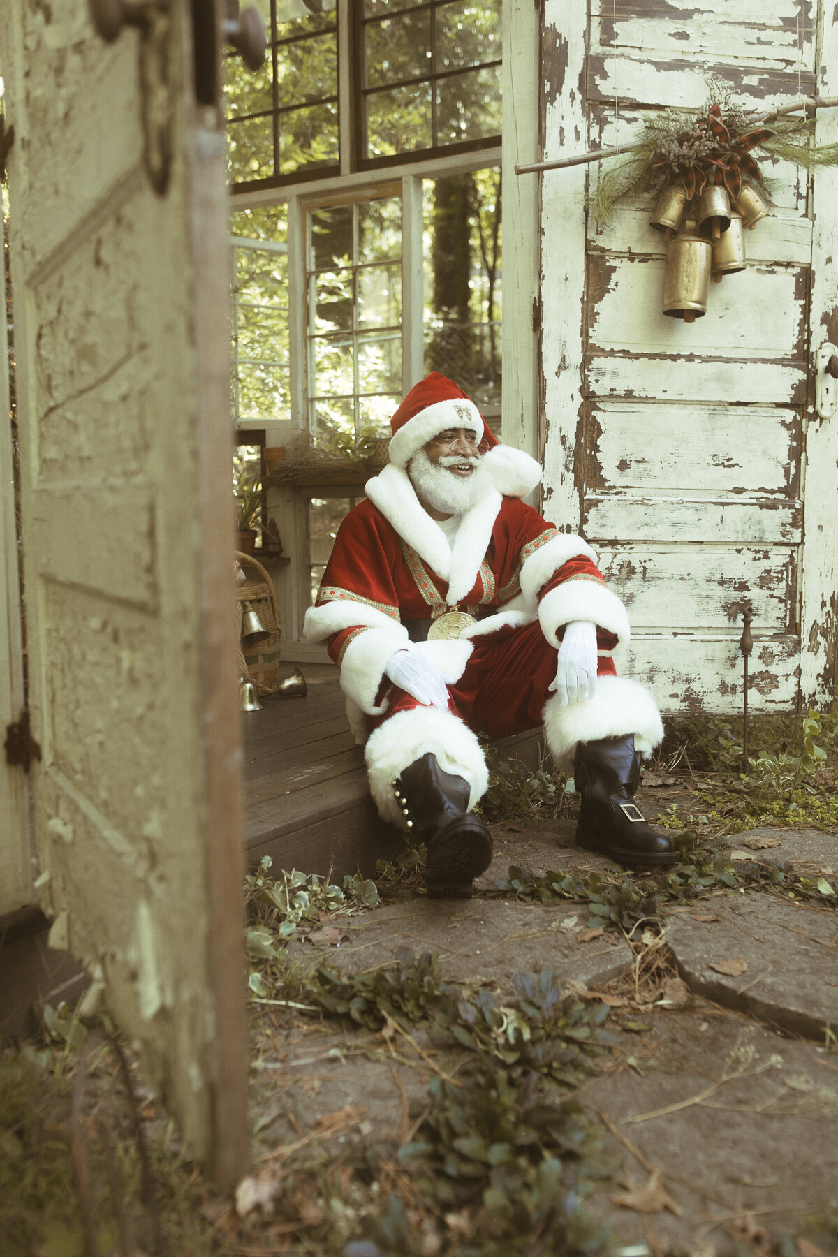 The Black Santa of Atlanta sits in the doorway of Das Hinterhaus in Marietta, GA. 