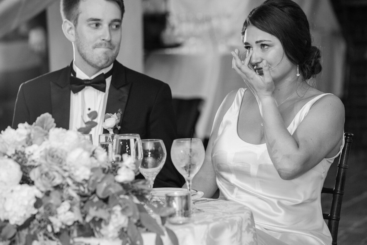 Groom looks to Bride who is crying during toasts at Turner Hill in Ipswich.