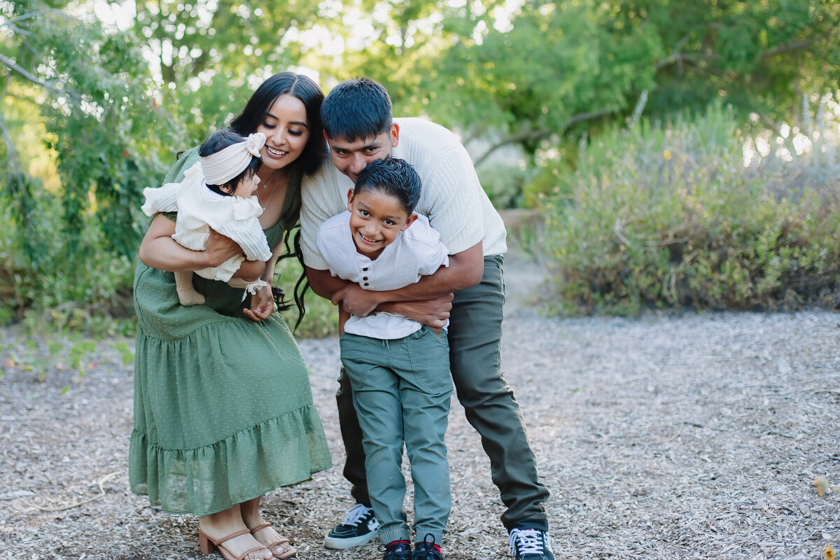 Parents giving oldest child big hug