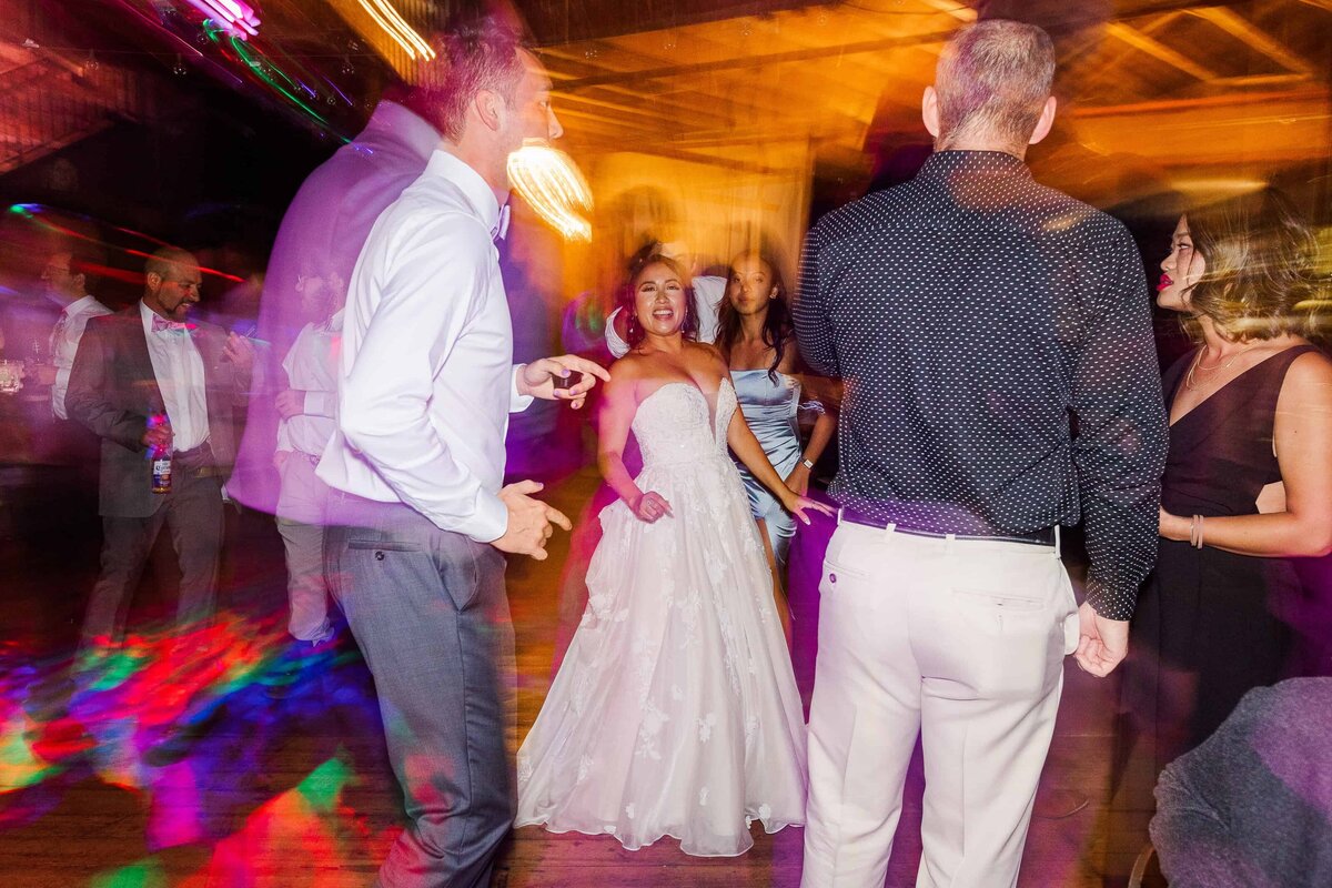 Hazy, colorful photograph of bride, dancing on the dance floor