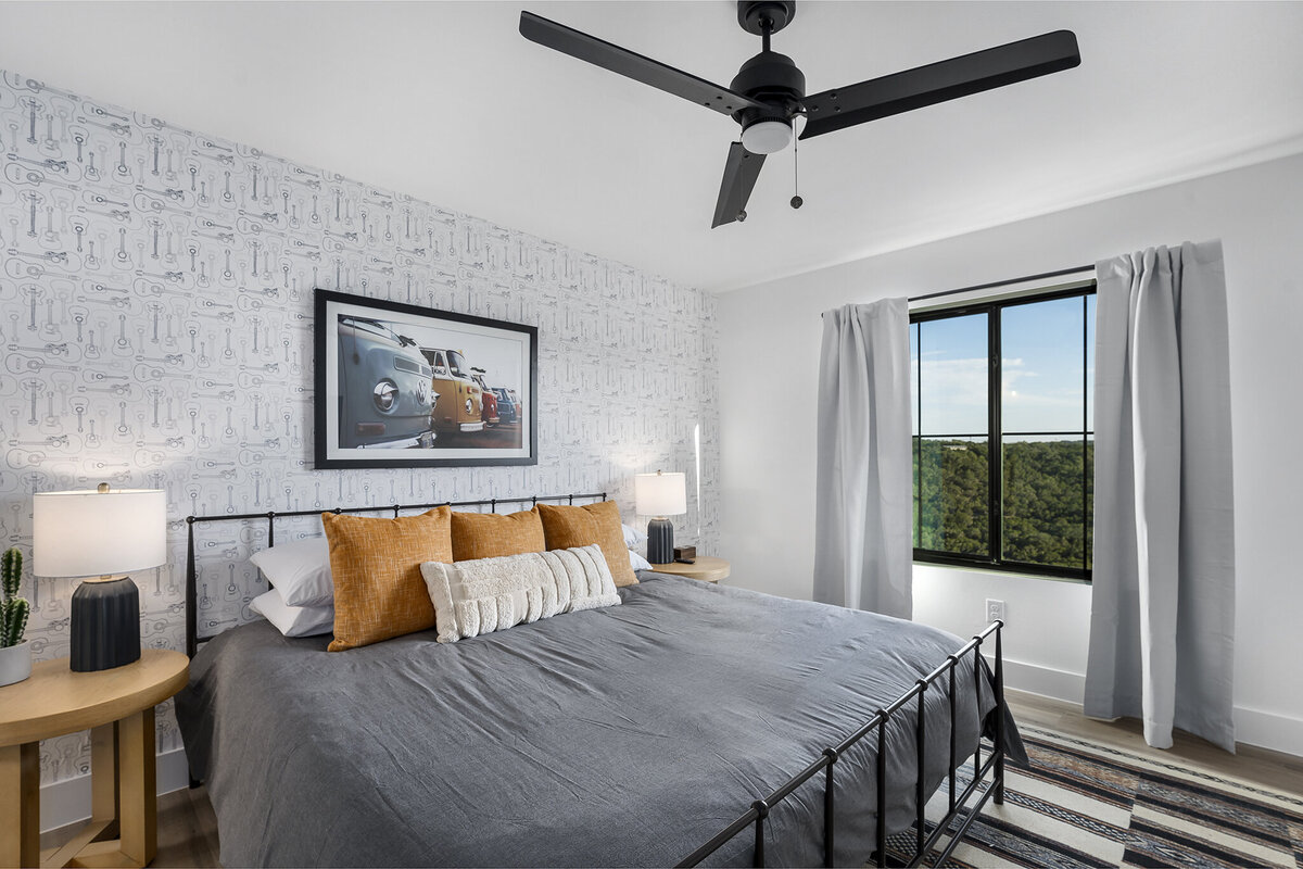 bedroom with wallpaper on feature wall