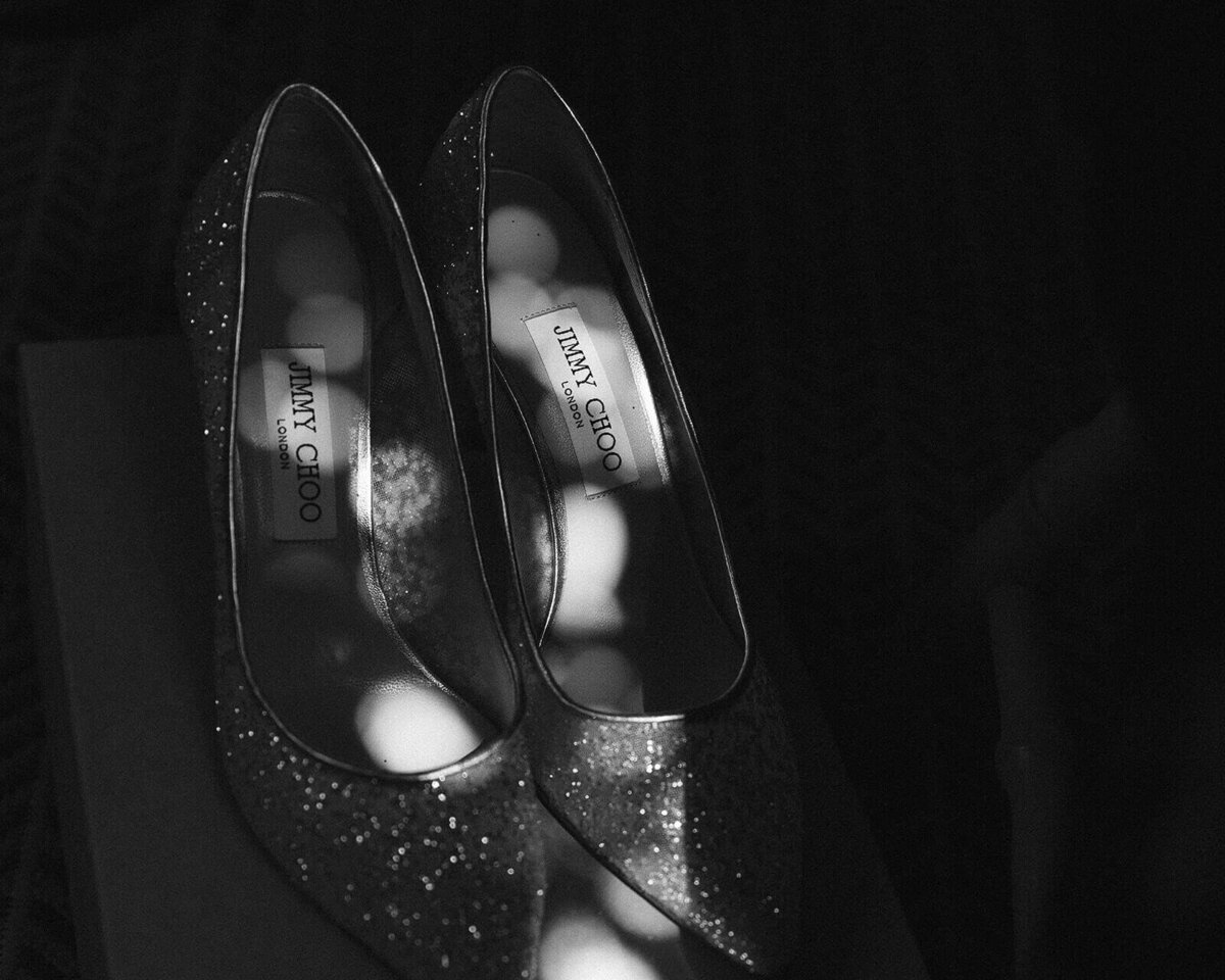 a pair of Jimmy Choo's glisten in the sunlight.