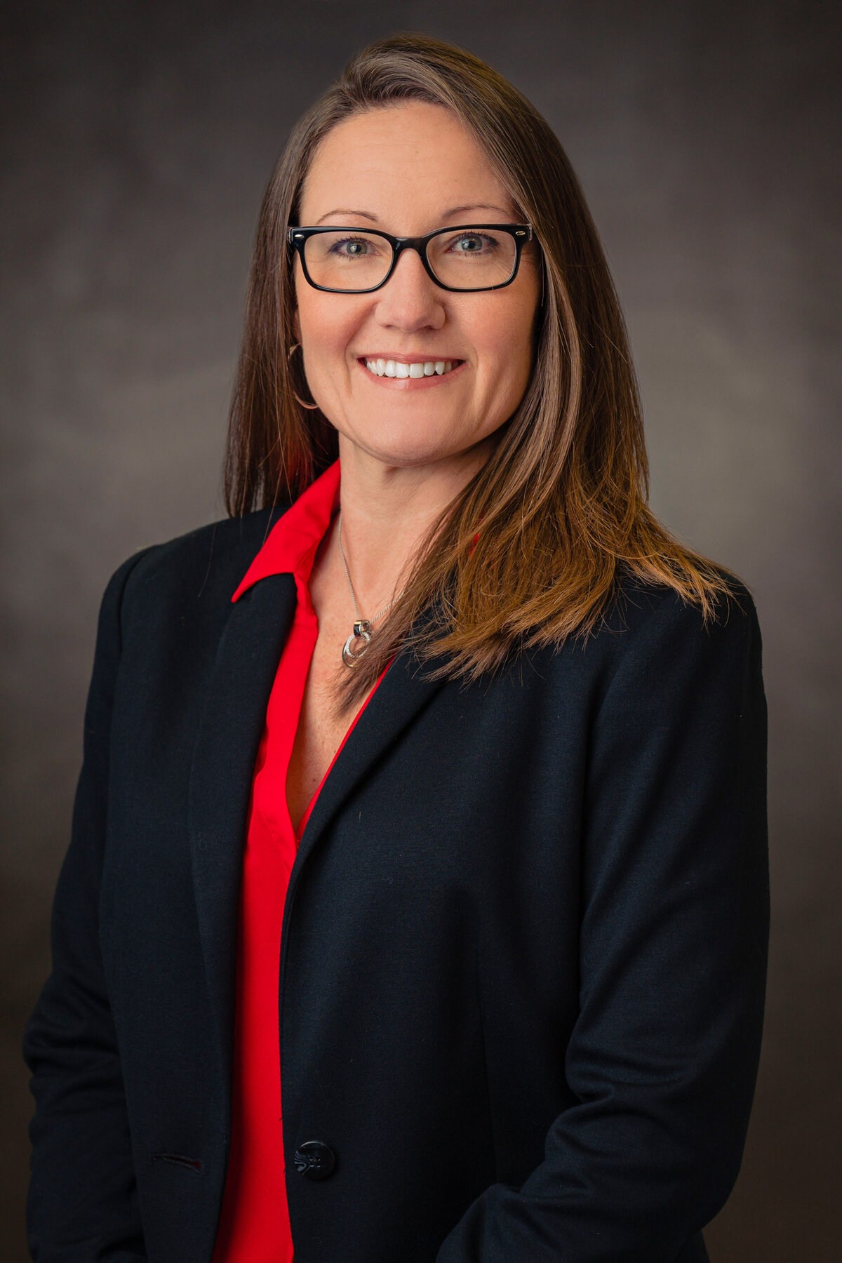 kansas-city-headshot_backdrop-standard-photography-0101-woman-in-glasses-in-black-blazer-headshot