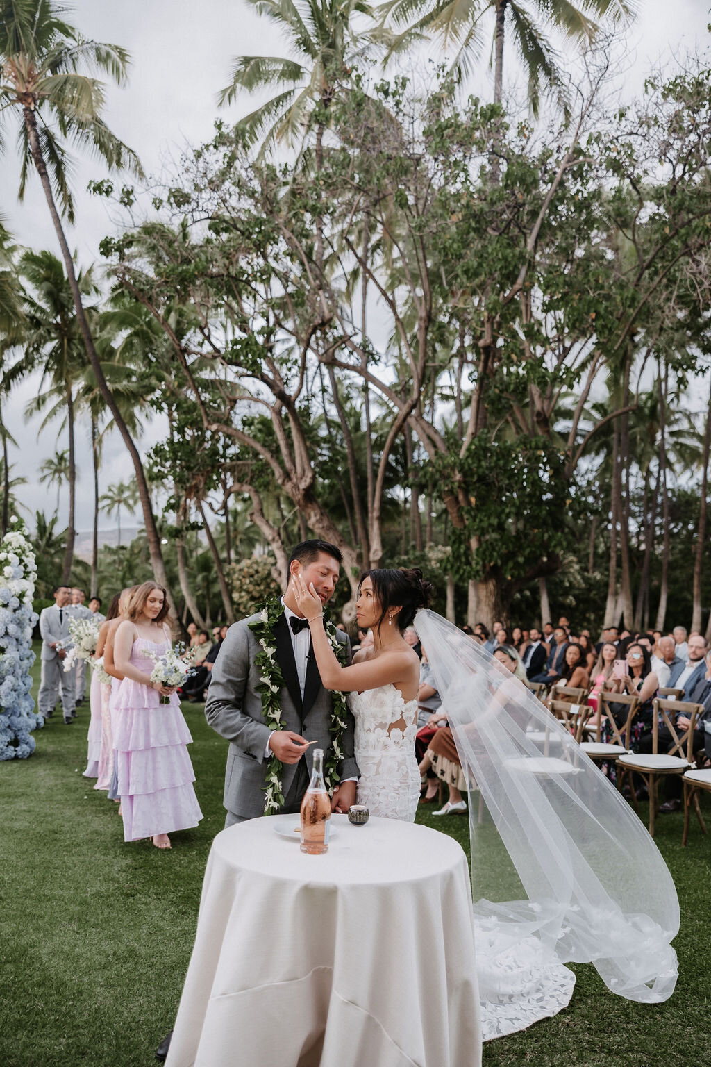 bride and groom taking communion at religious ceremony at lanikuhonua hawaii