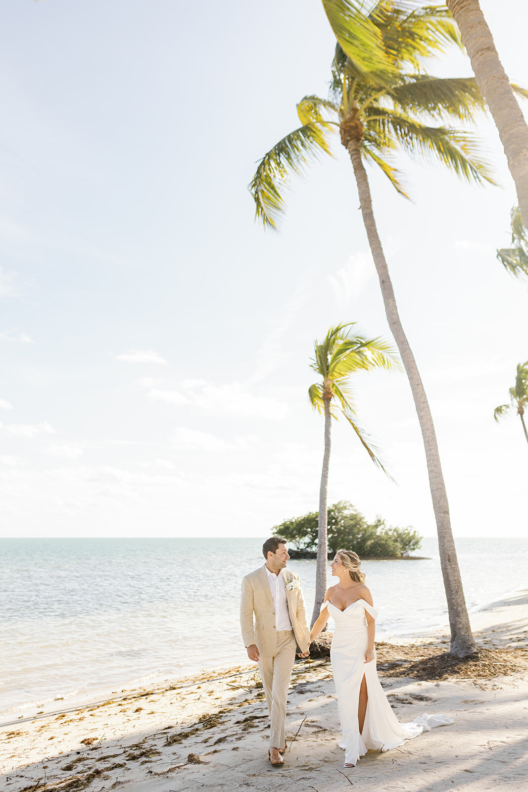 Monica and Austyn meet for their emotional first look under the palm trees at their Casitas at Cheeca wedding.