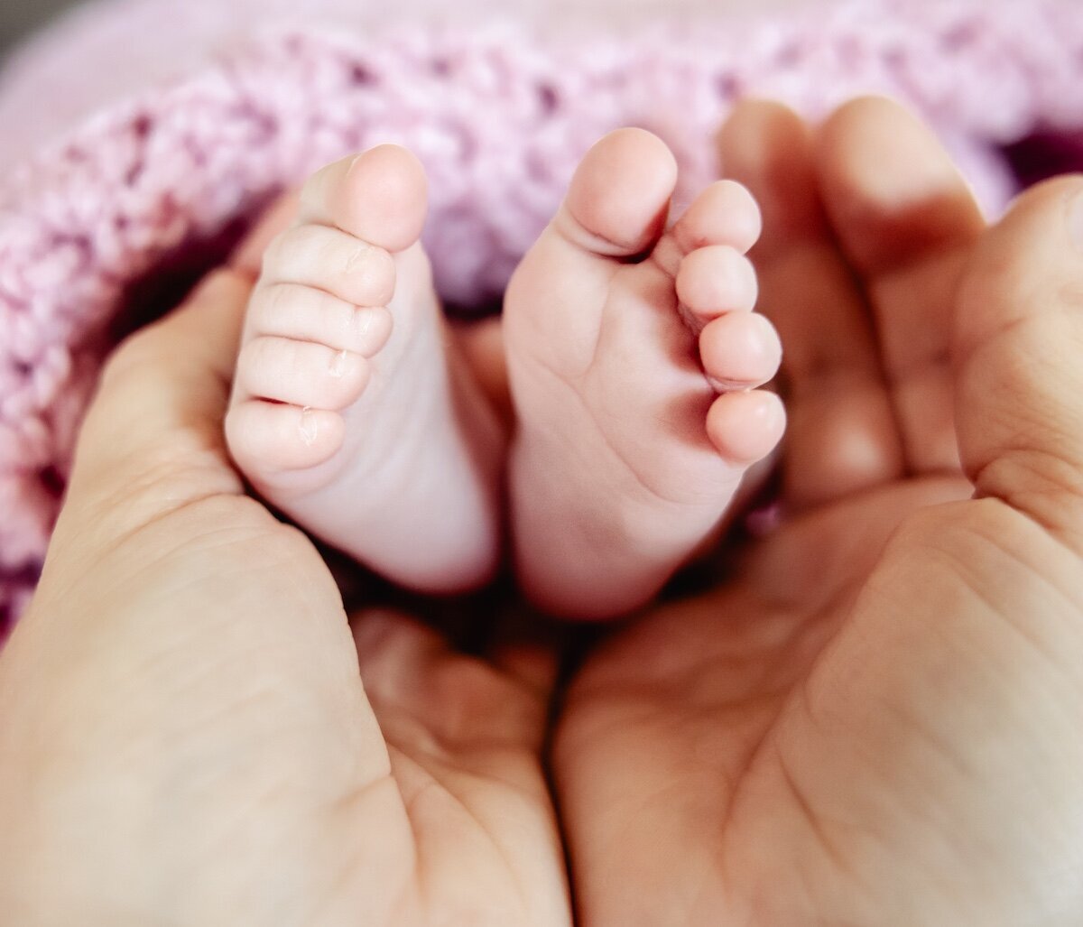 a closeup of a newborn baby's toes