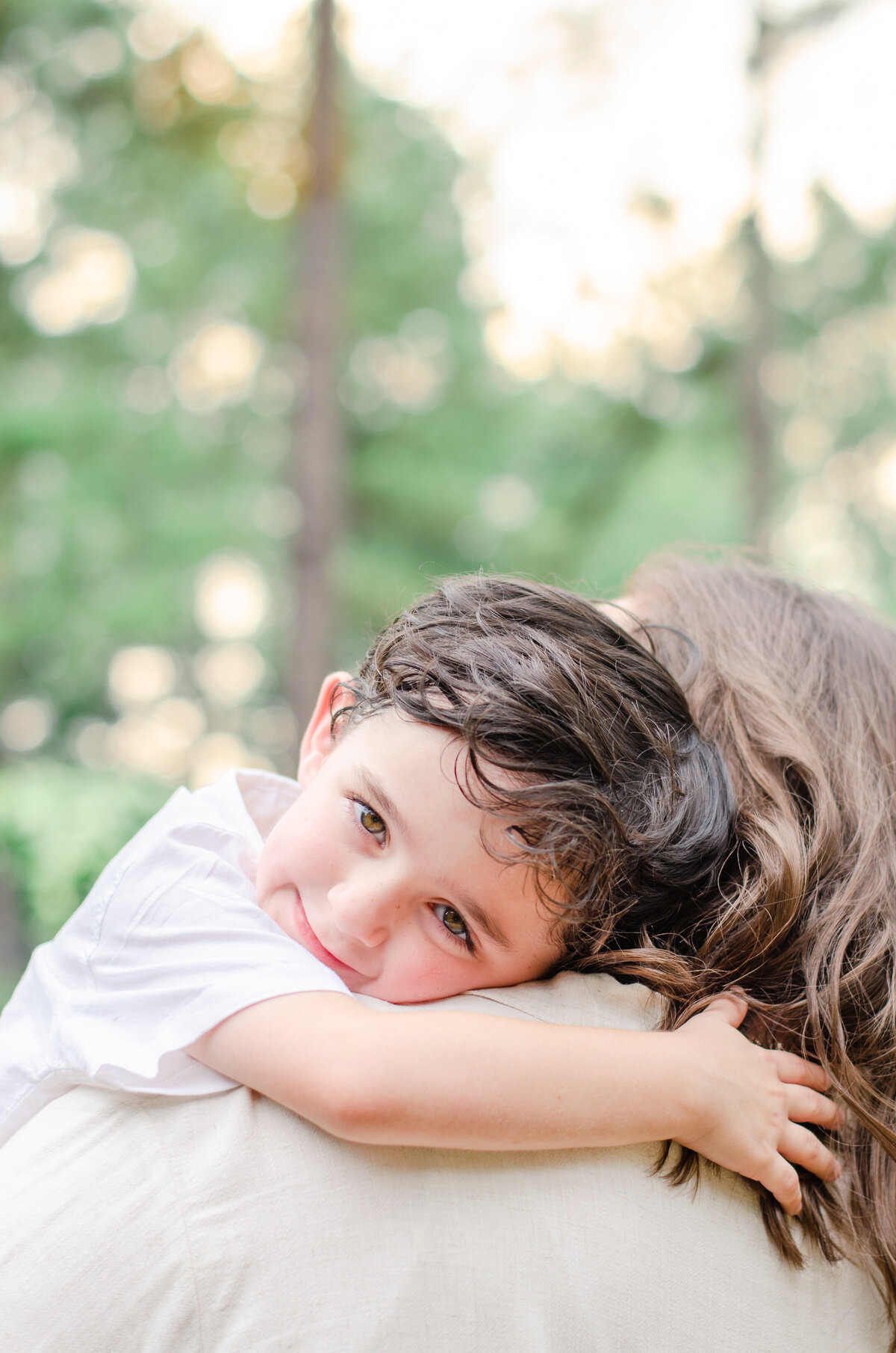 a boy hugs his mother