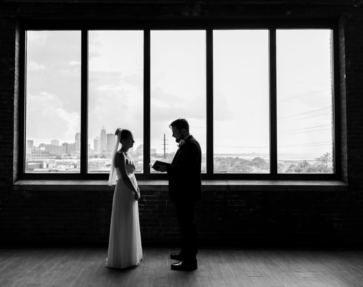 couple sharing private vows before their wedding ceremony overlooking the Cleveland skyline at the Ariel International Center