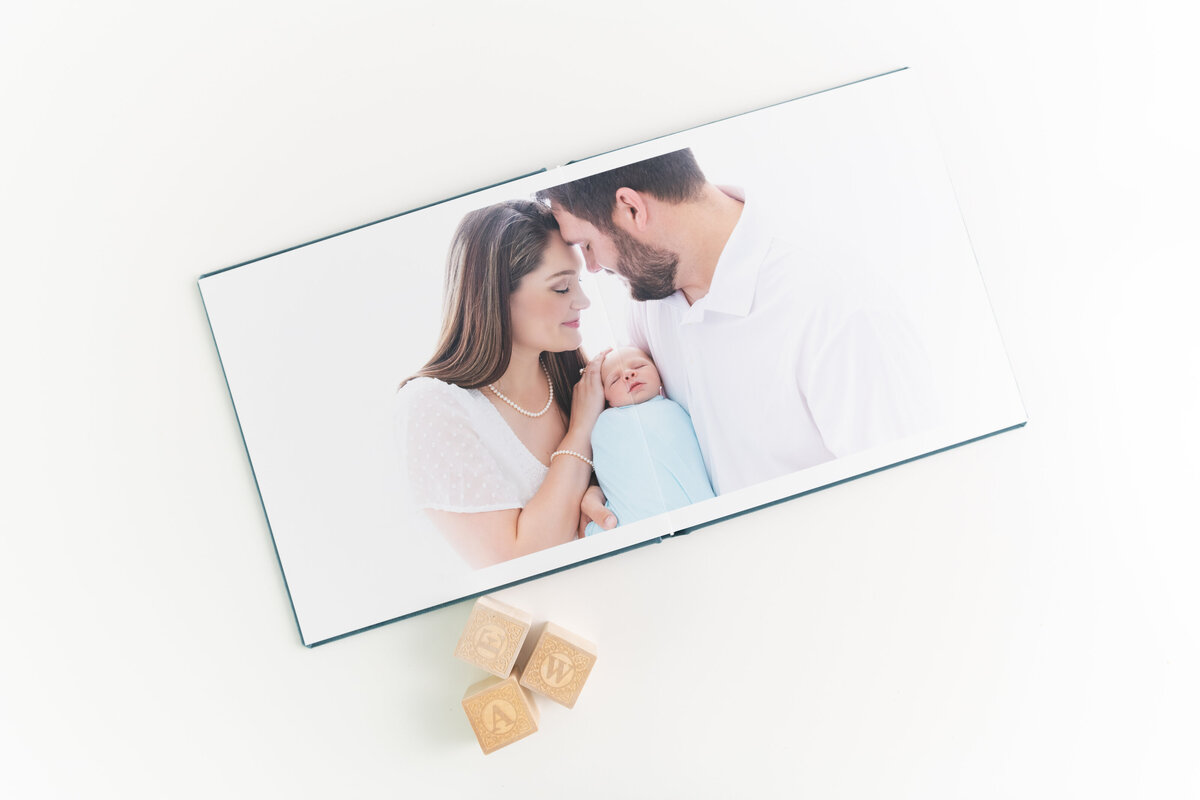A newborn photo session in a frame with wood blocks on a table