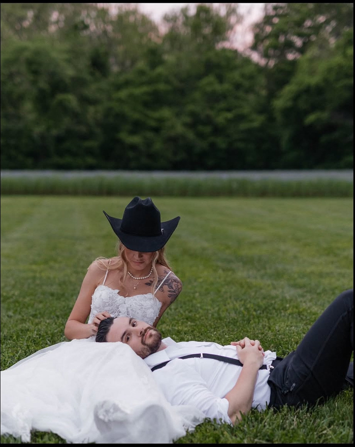 Groom laying down on brides lap