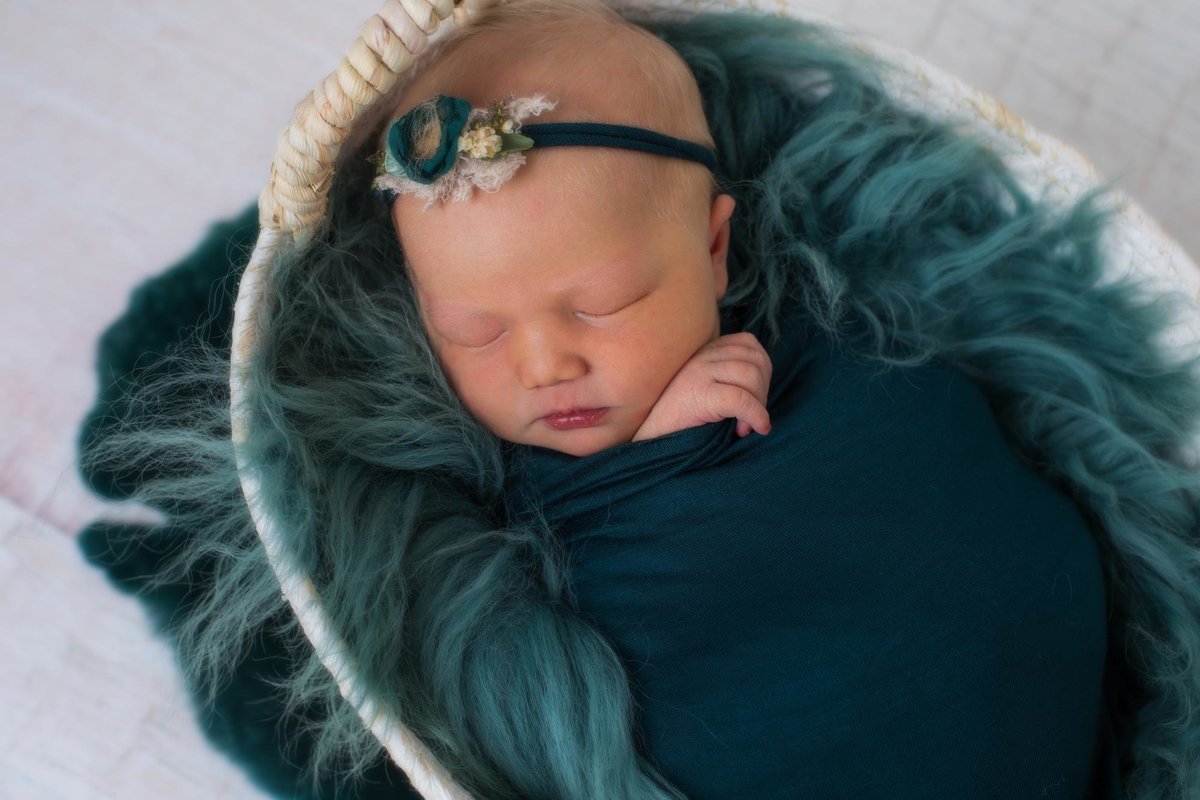 Baby girl in emerald green newborn photos