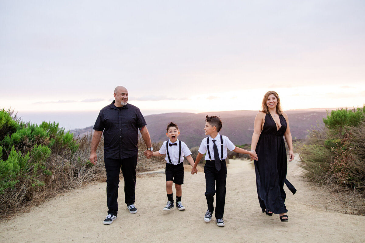 bridal party cheers as bride and groom kiss