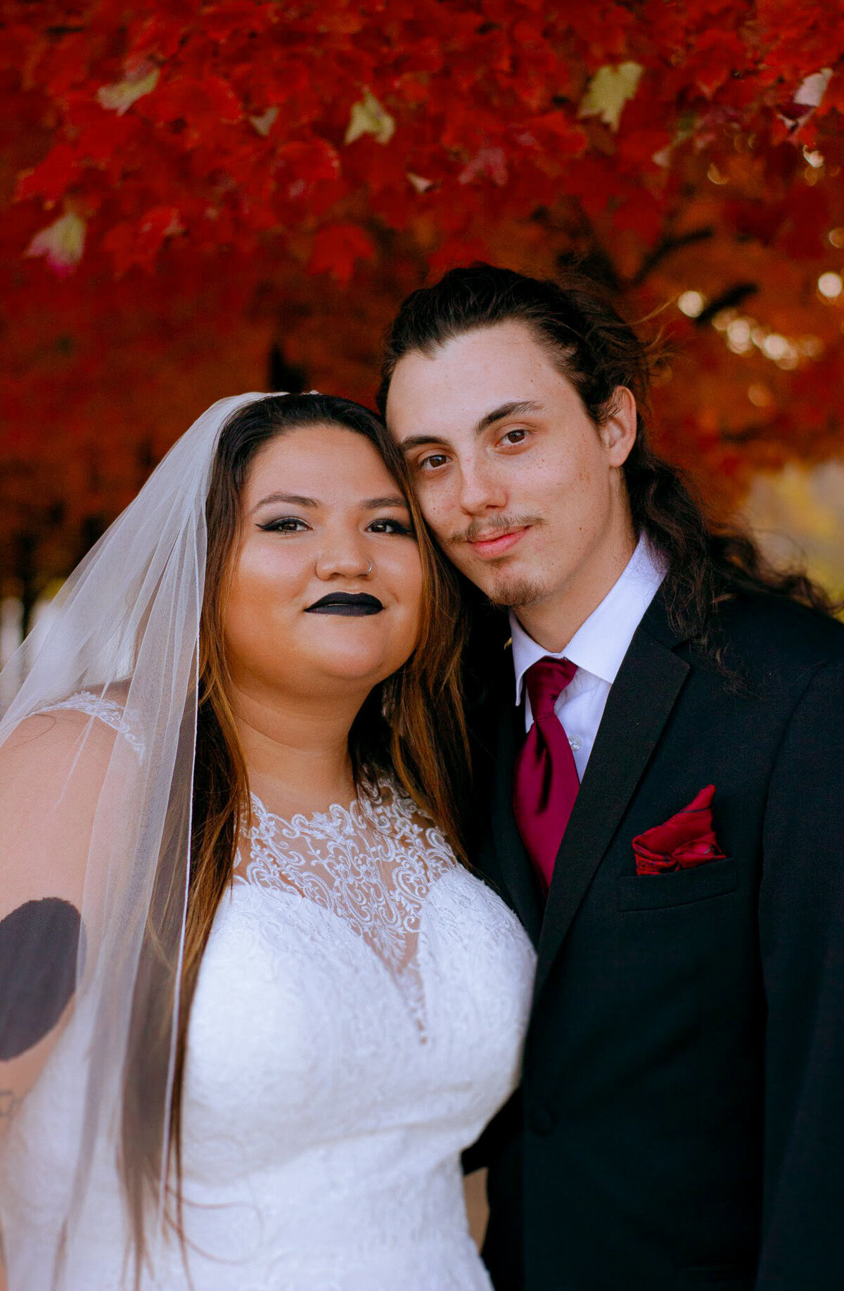 A tattooed couple laughing during their Springfield, MO elopement, captured by Chelsea Stanford.