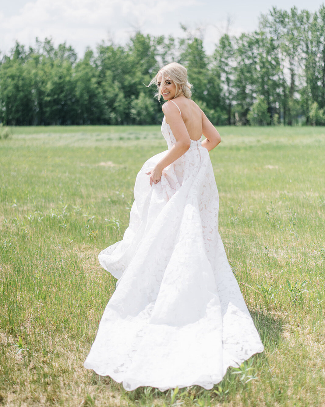 Bride wearing classic wedding gown from Delica Bridal, an elegant bridal boutique based in Edmonton, Alberta. Featured on the Brontë Bride Vendor Guide.