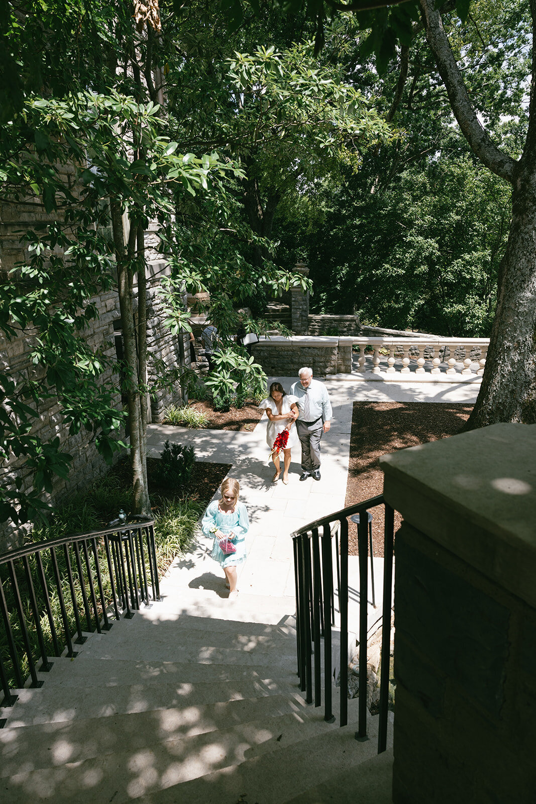 Father walks daughter up a stone staircase on her way to her elopement ceremony in Nashville, TN.