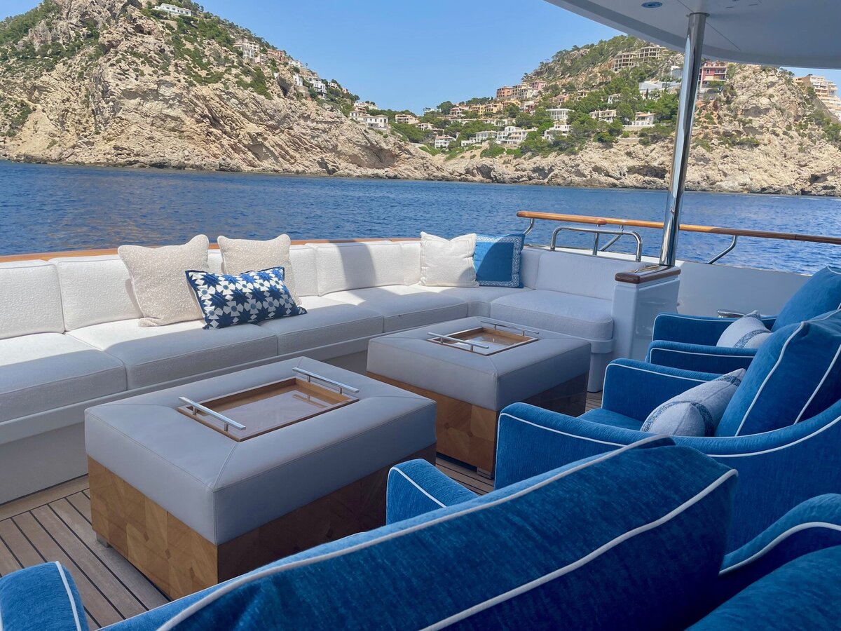 High end luxurious yacht with creamy cushions, blue lounge chairs with white welting.