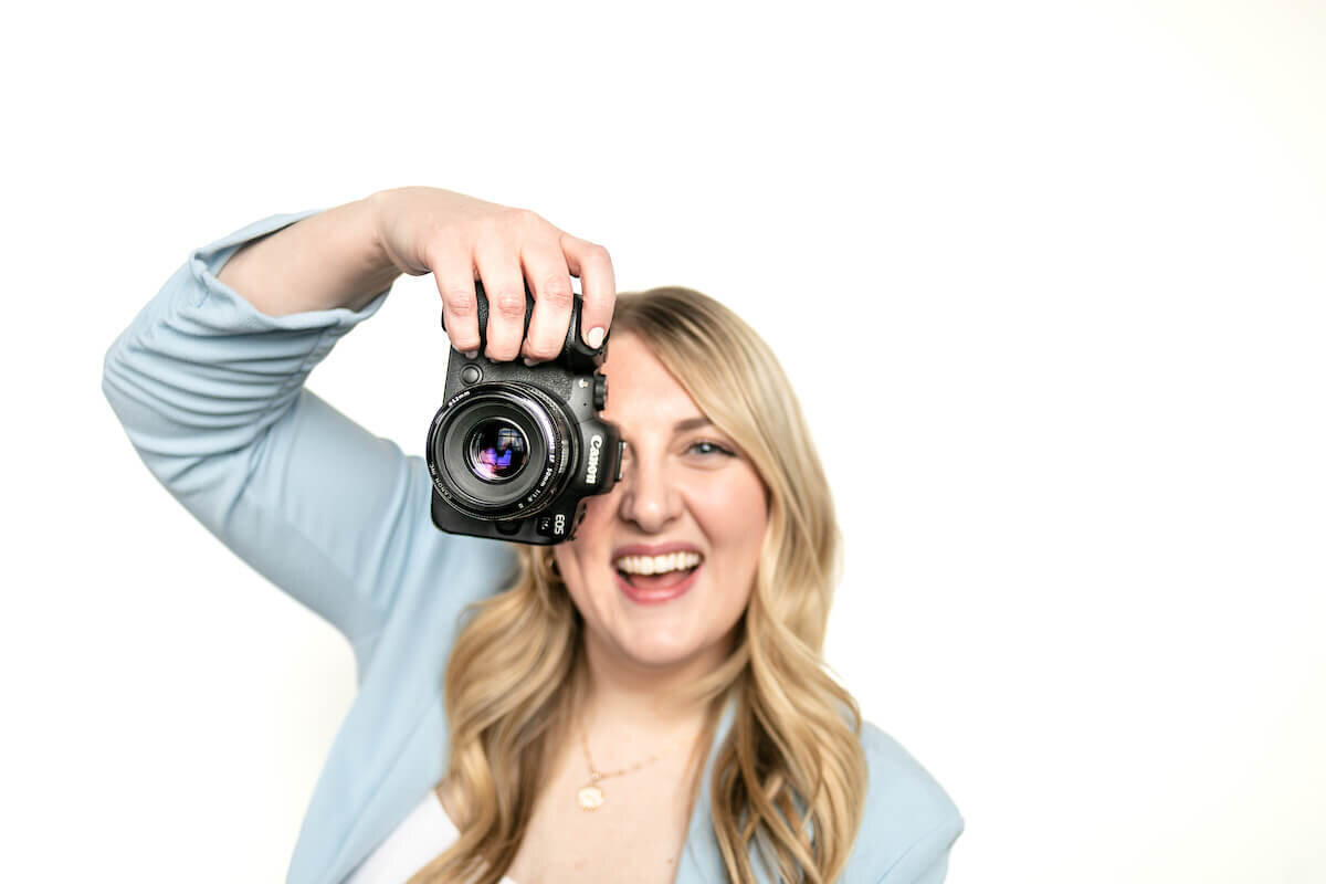 Woman with blonde hair holding camera