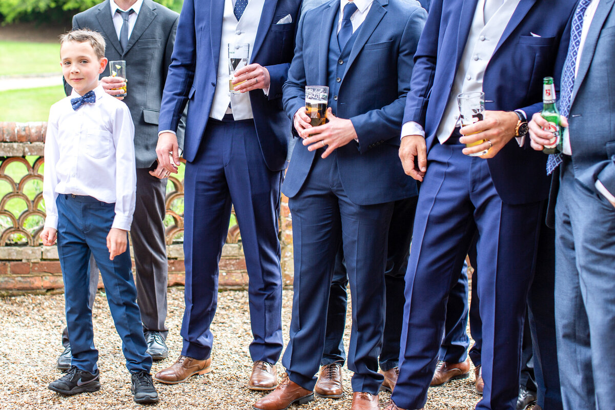 Son watching bride come down aisle with groomsmen