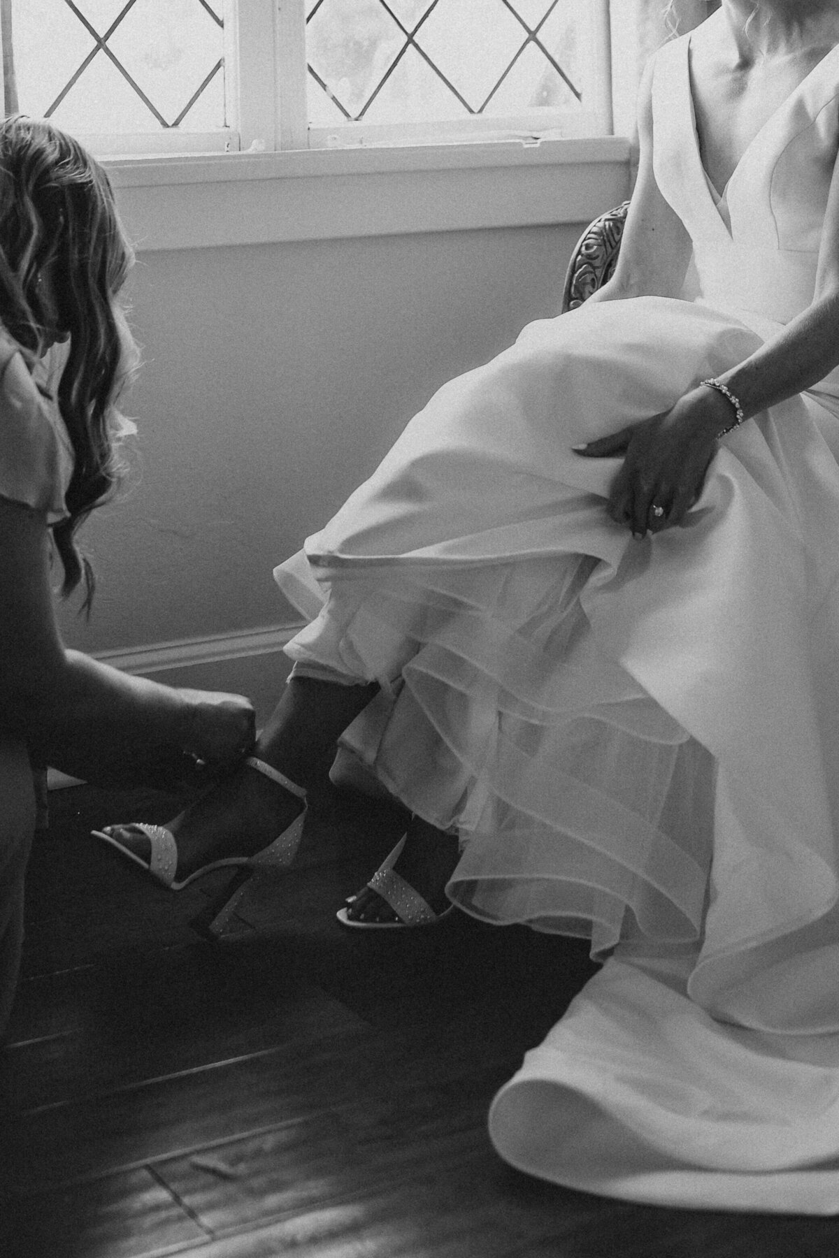 bride-putting-on-wedding-shoes-connecticut-wedding-planner