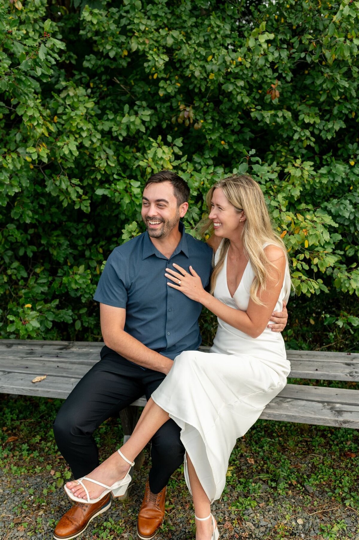 Smiling couple embrace at Lightfoot and Wolfville