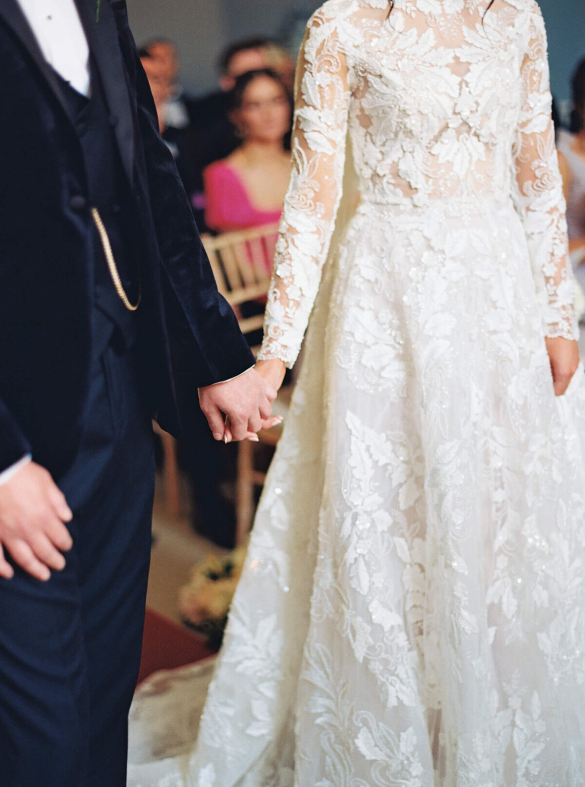 A wedding day photo of the bride and groom holding hands at the alter at Luttrellstown Castle