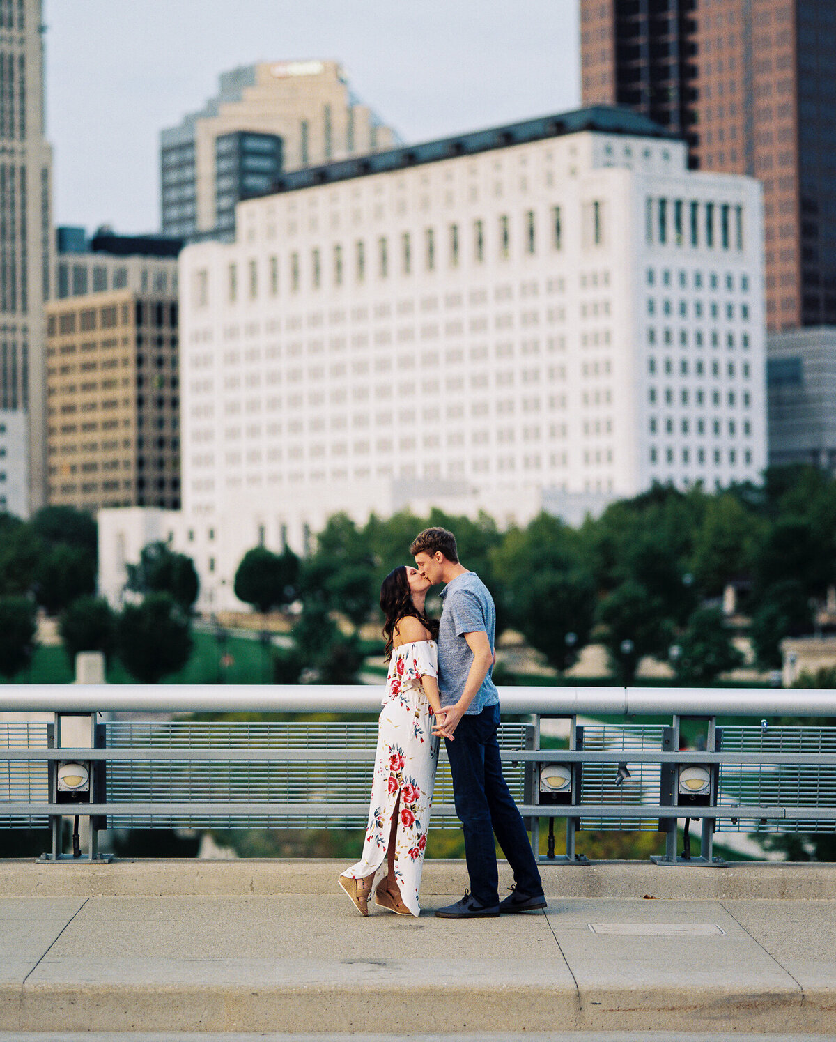 Couple shares a kiss in front of the Columbus skyline