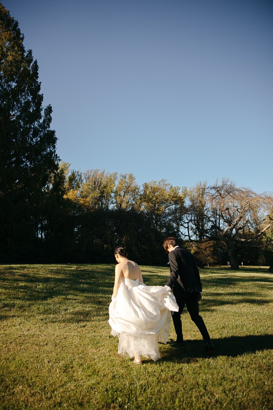 Wedding couple walking in an open field area
